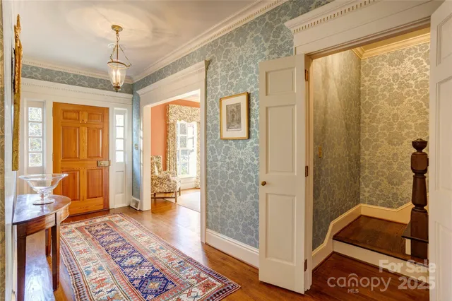 a view of a hallway with furniture and a window