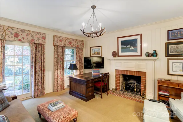 a living room with furniture a window and a fireplace