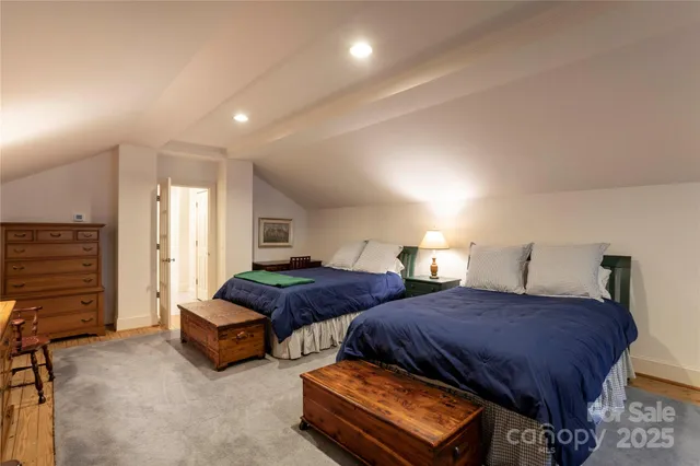 a spacious bedroom with two beds and painted walls