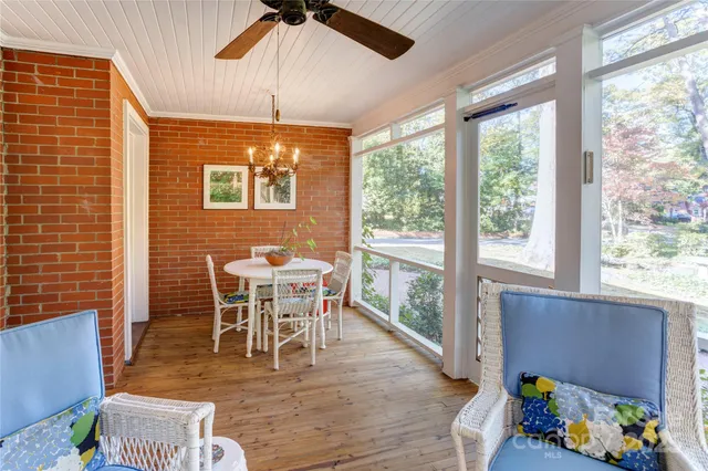a dining room with furniture garden view and a large window