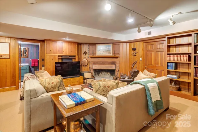 a living room with furniture a fireplace and a flat screen tv