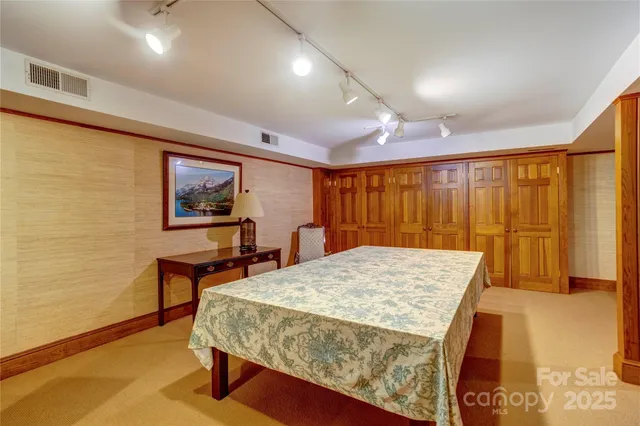 a bedroom with a bed and a table in it