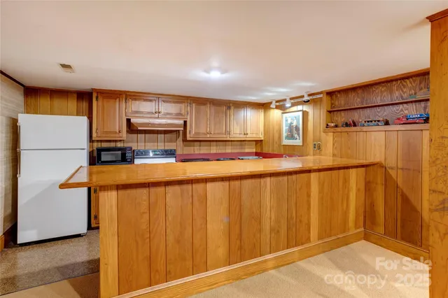 a kitchen with stainless steel appliances a refrigerator and a stove top oven