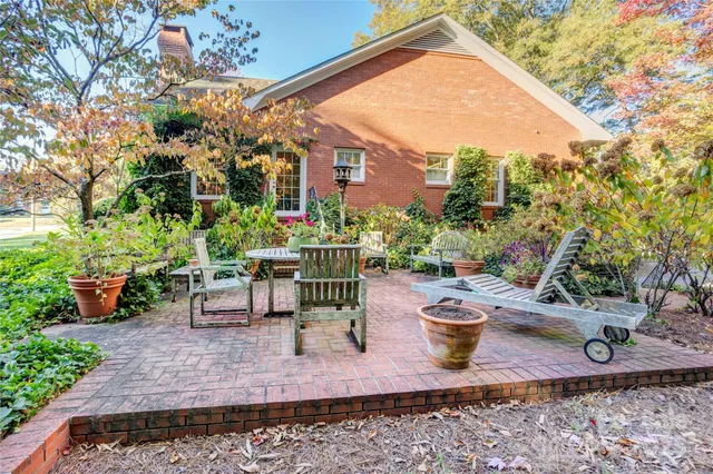 a view of a chairs and table in backyard