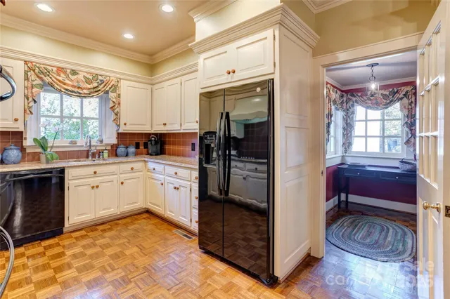 a kitchen with a refrigerator and a stove top oven