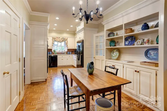 a view of a dining room with furniture and chandelier