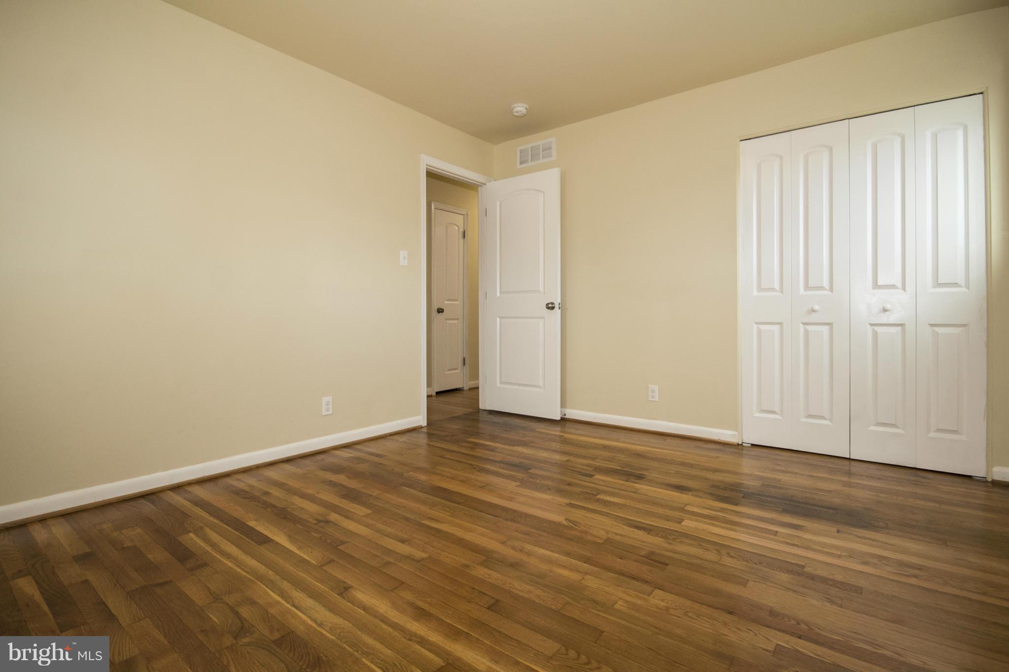 7413 Allmont Road Baltimore, MD 21244 - Photo 22 of 27 a view of an empty room with wooden floor