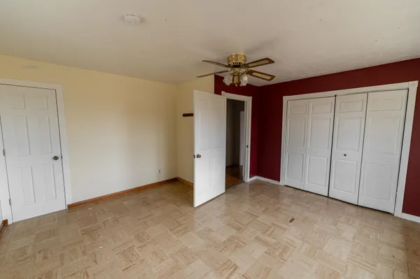 a bathroom with a toilet and a mirror