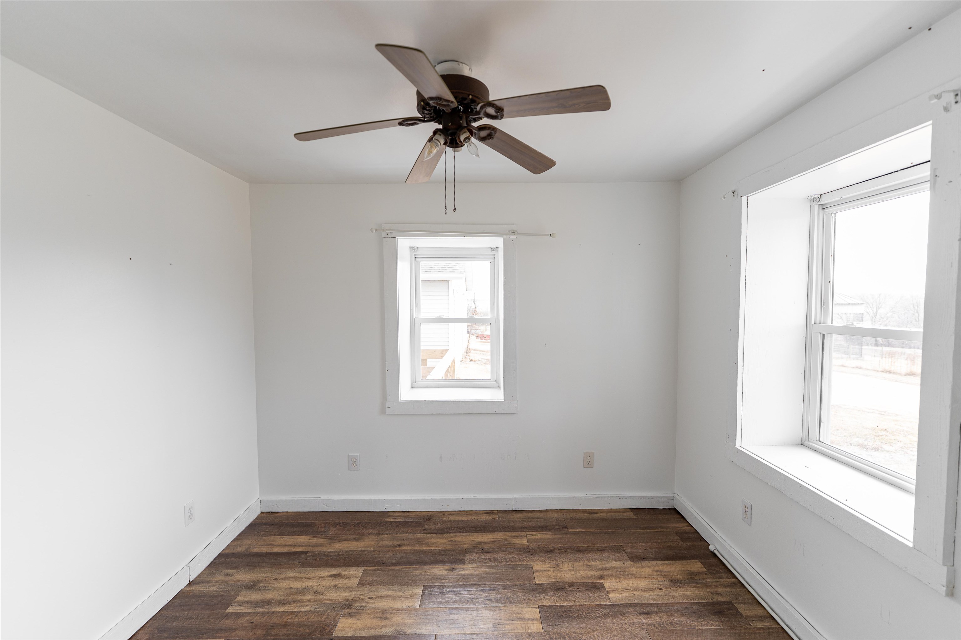 3651 North Brookville Road Forreston, IL 61030 - Photo 18 of 66 a view of an empty room with wooden floor and a window
