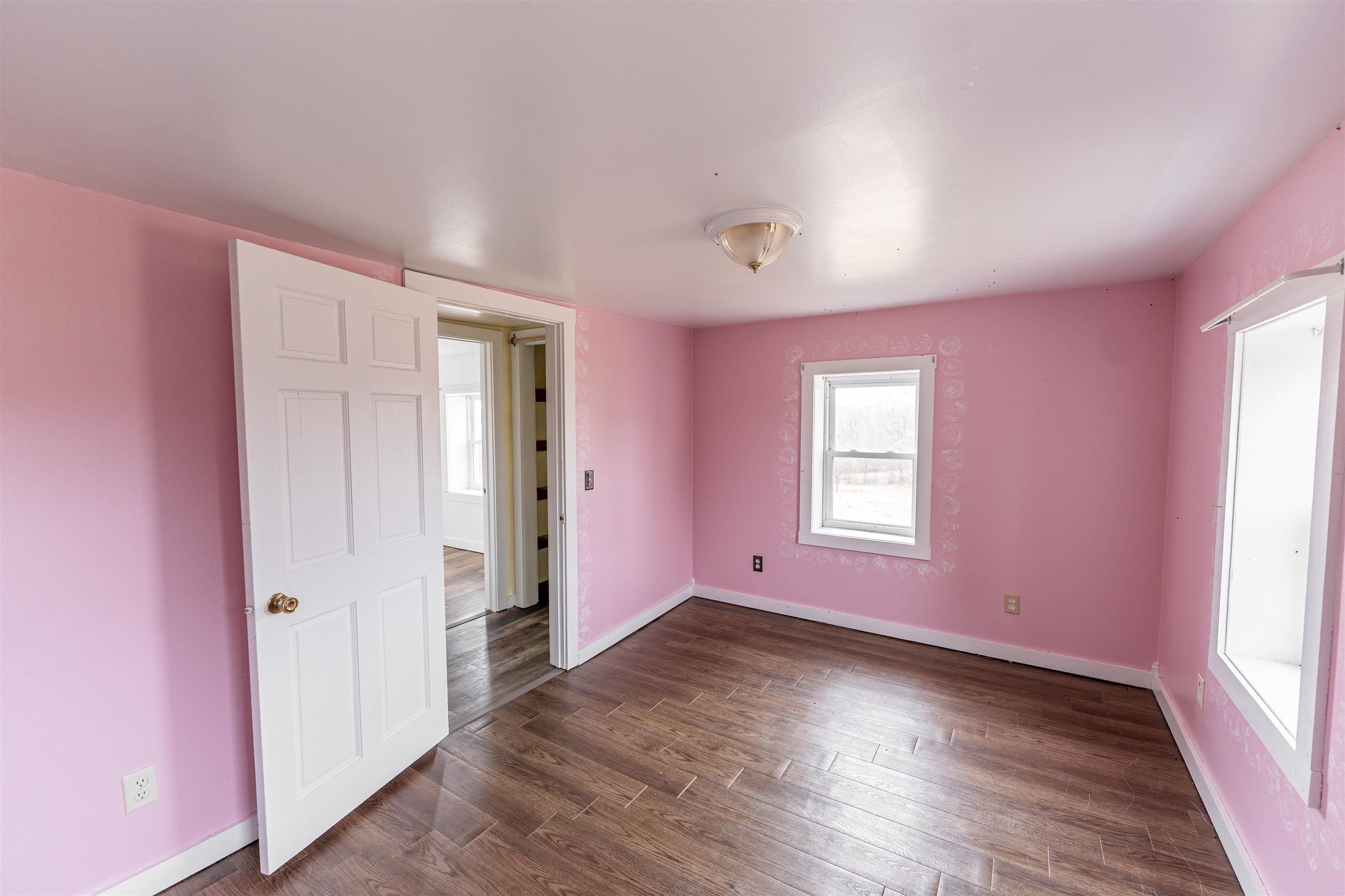 3651 North Brookville Road Forreston, IL 61030 - Photo 58 of 66 an empty room with wooden floor and windows