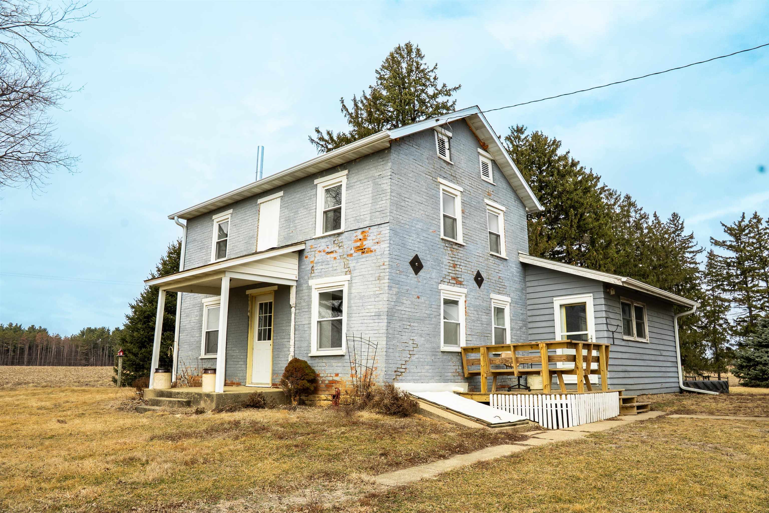 3651 North Brookville Road Forreston, IL 61030 - Photo 7 of 66 a front view of a house with a yard patio and fire pit