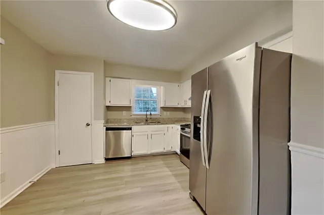 a kitchen with a refrigerator sink and stove