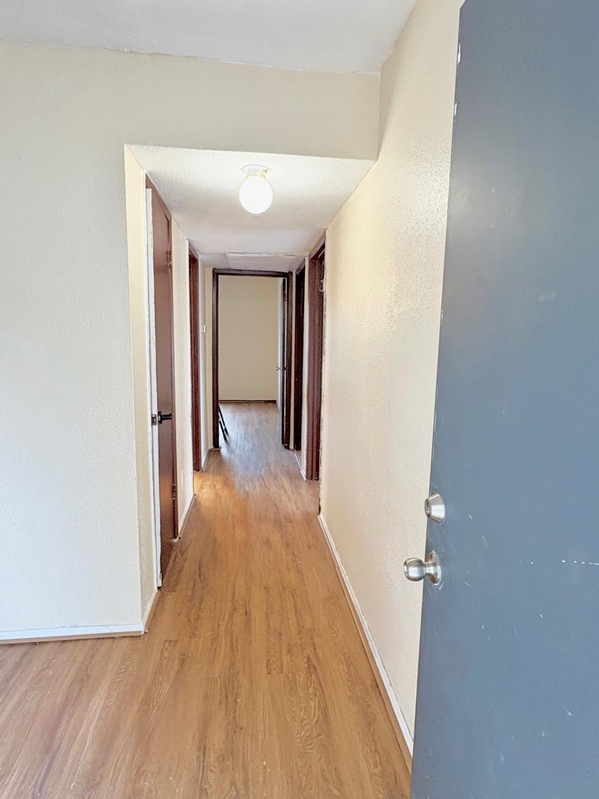 6200 West Tidwell Road, Unit 606 Houston, TX 77092 - Photo 14 of 24 a view of a hallway with wooden floor