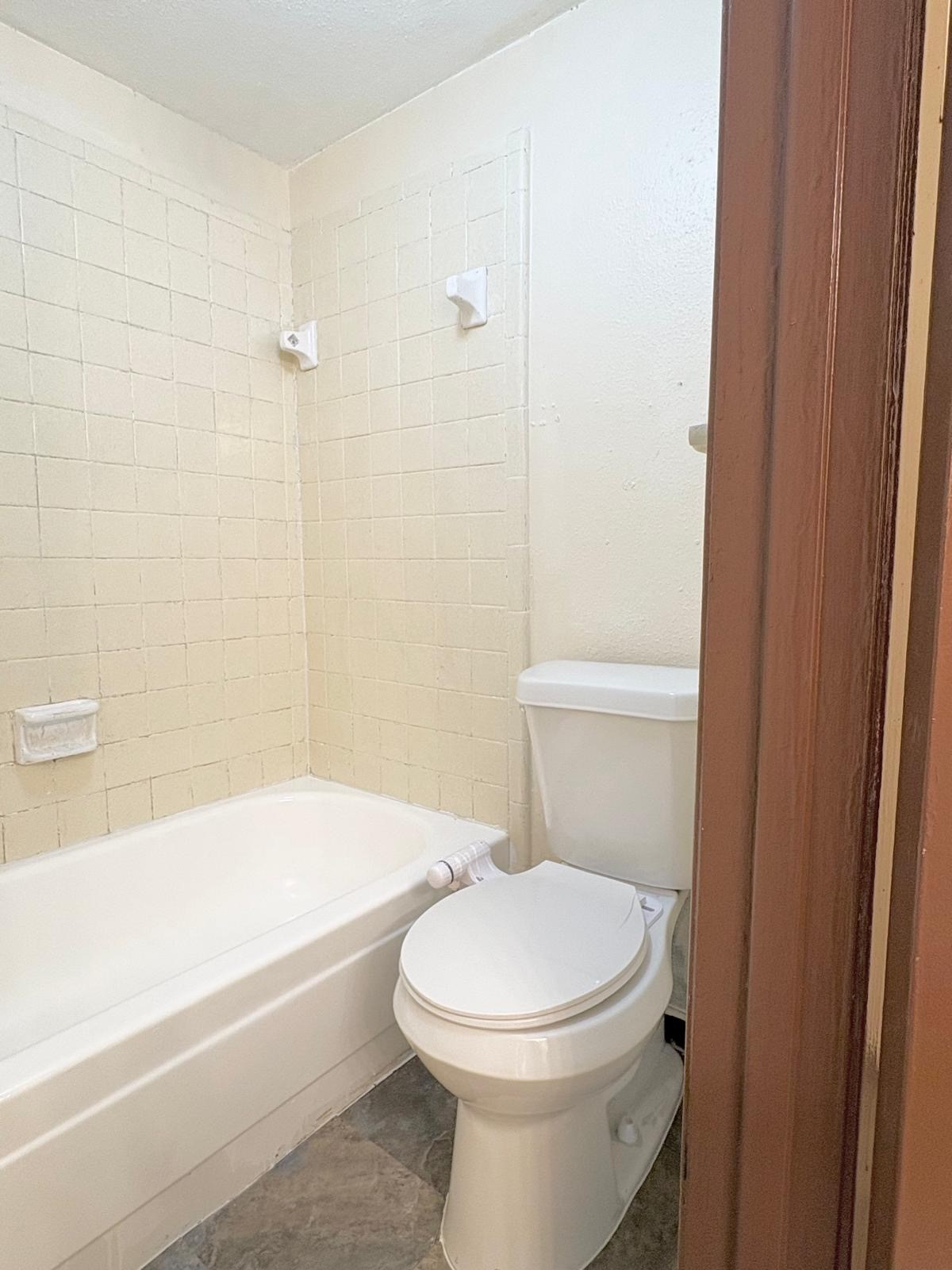 6200 West Tidwell Road, Unit 606 Houston, TX 77092 - Photo 19 of 24 a white toilet sitting next to a bath tub