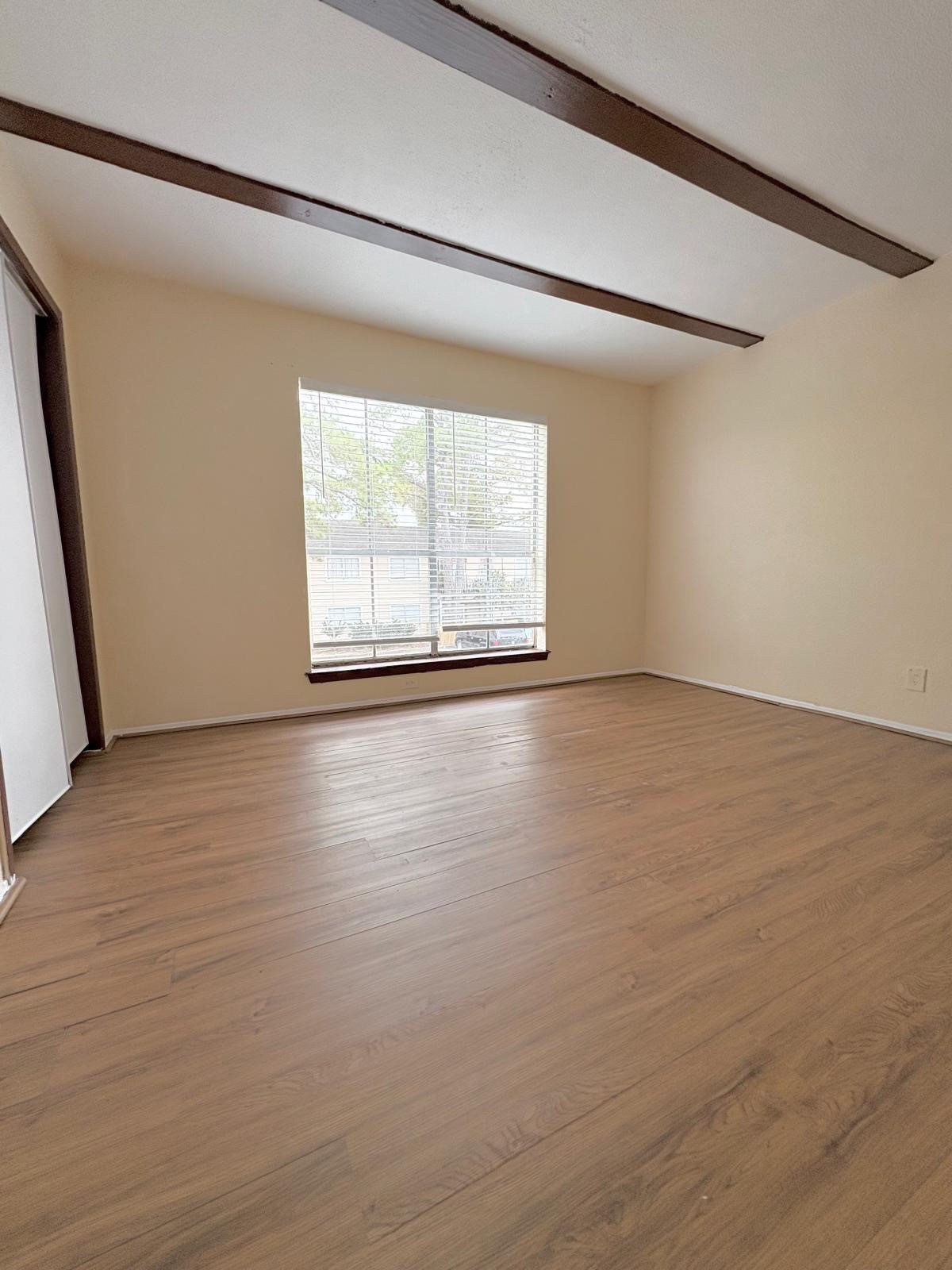 6200 West Tidwell Road, Unit 606 Houston, TX 77092 - Photo 24 of 24 a view of an empty room with wooden floor and a window