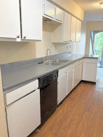 a kitchen with a sink and cabinets