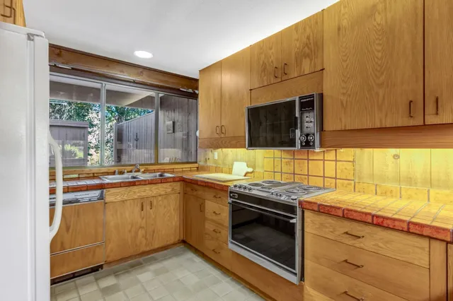 a kitchen with stainless steel appliances granite countertop a sink and cabinets