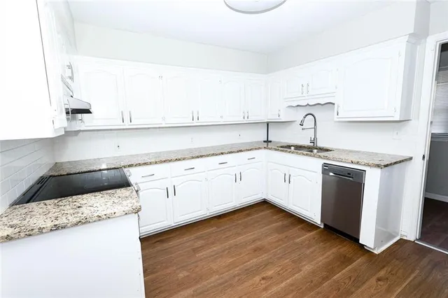 a kitchen with a white cabinets and white appliances