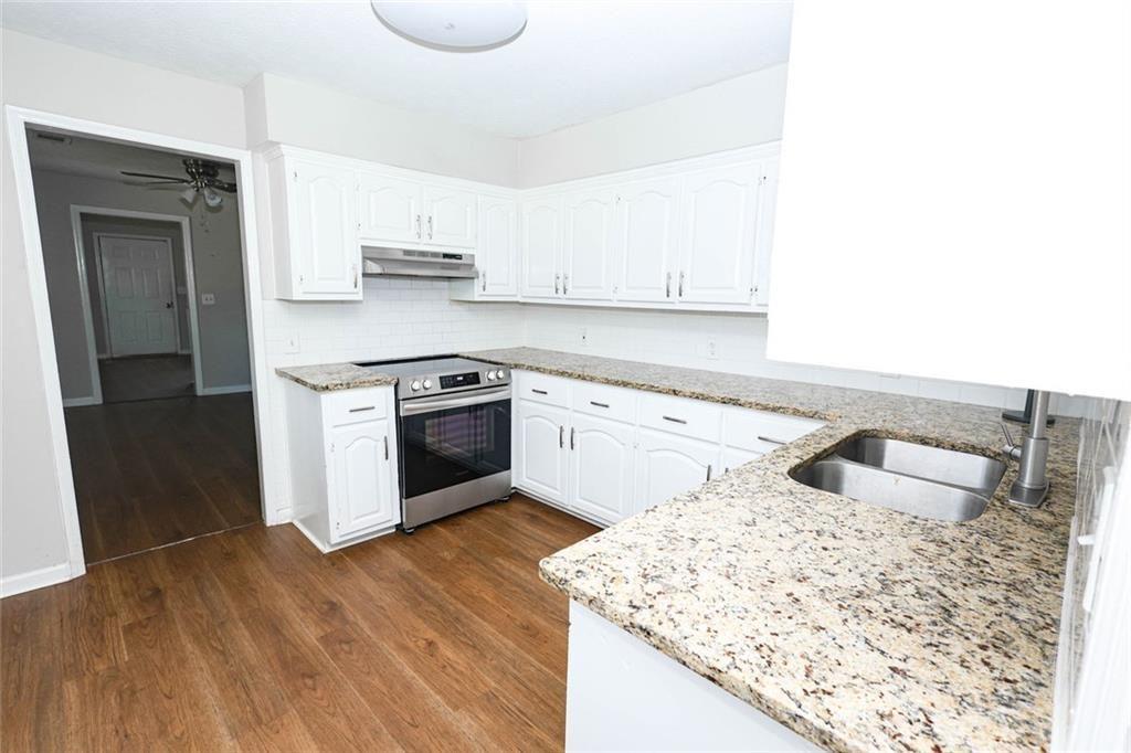 218 East Bonacre Road Cataula, GA 31804 - Photo 14 of 36 a kitchen with a sink stove and cabinets