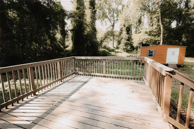 a view of a yard with wooden fence and trees