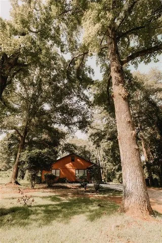 a view of house with trees in the background