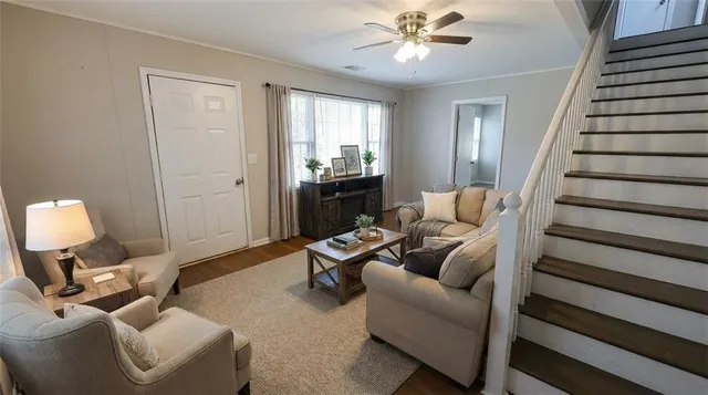 a living room with furniture and a chandelier