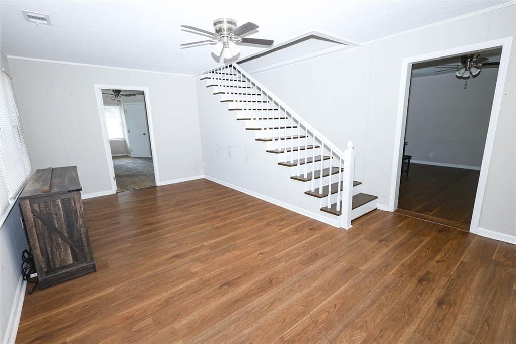 218 East Bonacre Road Cataula, GA 31804 - Photo 10 of 36 a view of an empty room with wooden floor and staircase