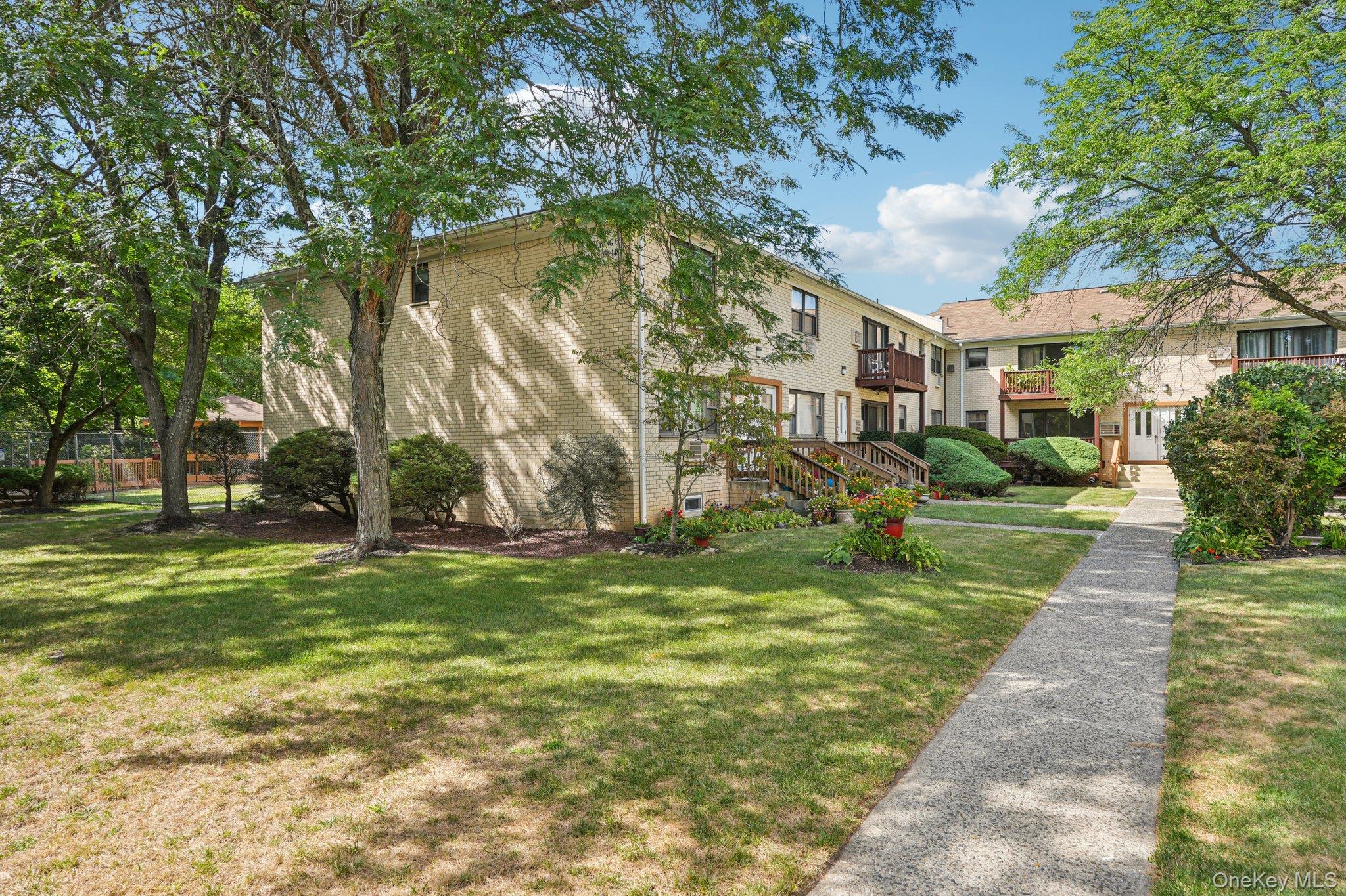 148 Sneden Place West, Unit 148 Spring Valley, NY 10977 - Photo 1 of 37 a view of a park with large trees