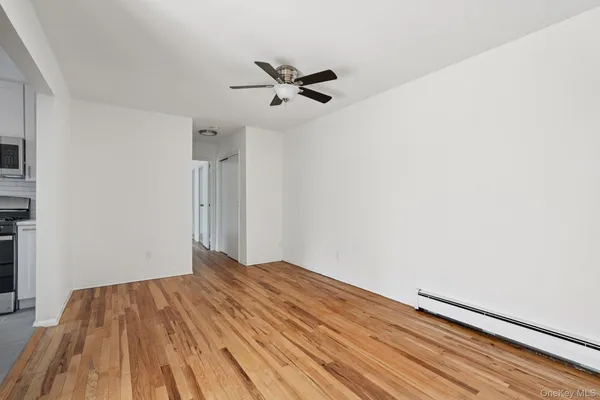 a view of empty room with wooden floor