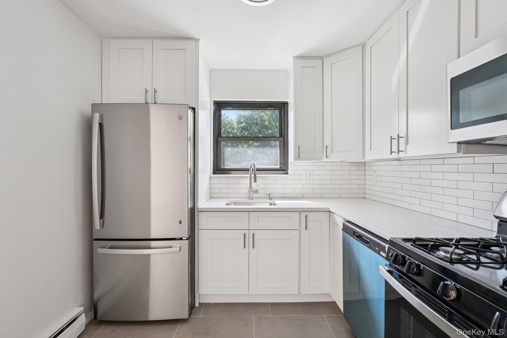 148 Sneden Place West, Unit 148 Spring Valley, NY 10977 - Photo 18 of 37 a kitchen with white cabinets and white appliances