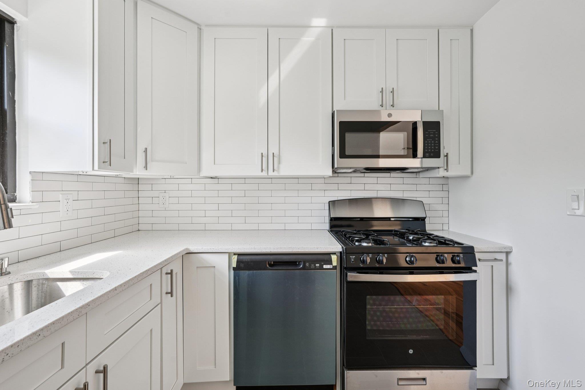 148 Sneden Place West, Unit 148 Spring Valley, NY 10977 - Photo 20 of 37 a kitchen with cabinets stainless steel appliances and a sink