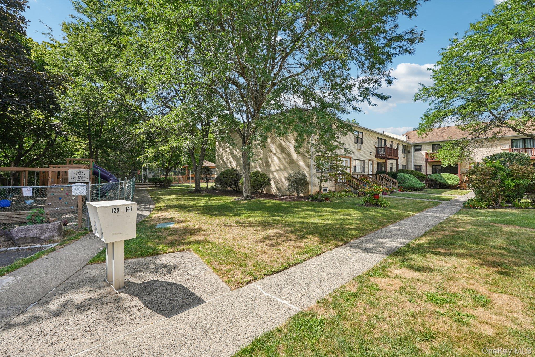 148 Sneden Place West, Unit 148 Spring Valley, NY 10977 - Photo 2 of 37 a table and chairs sitting in the middle of yard