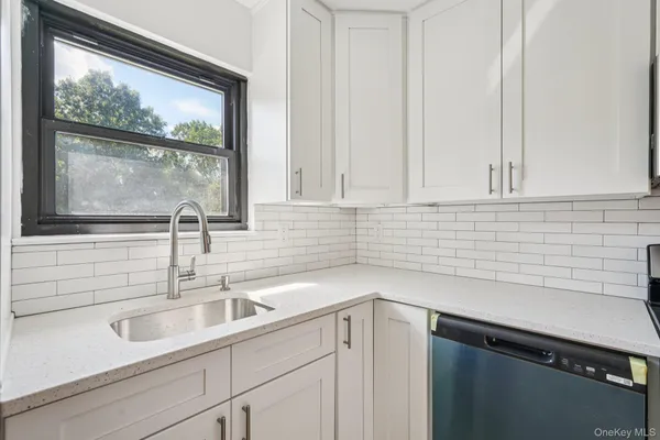 a view with a sink and cabinets