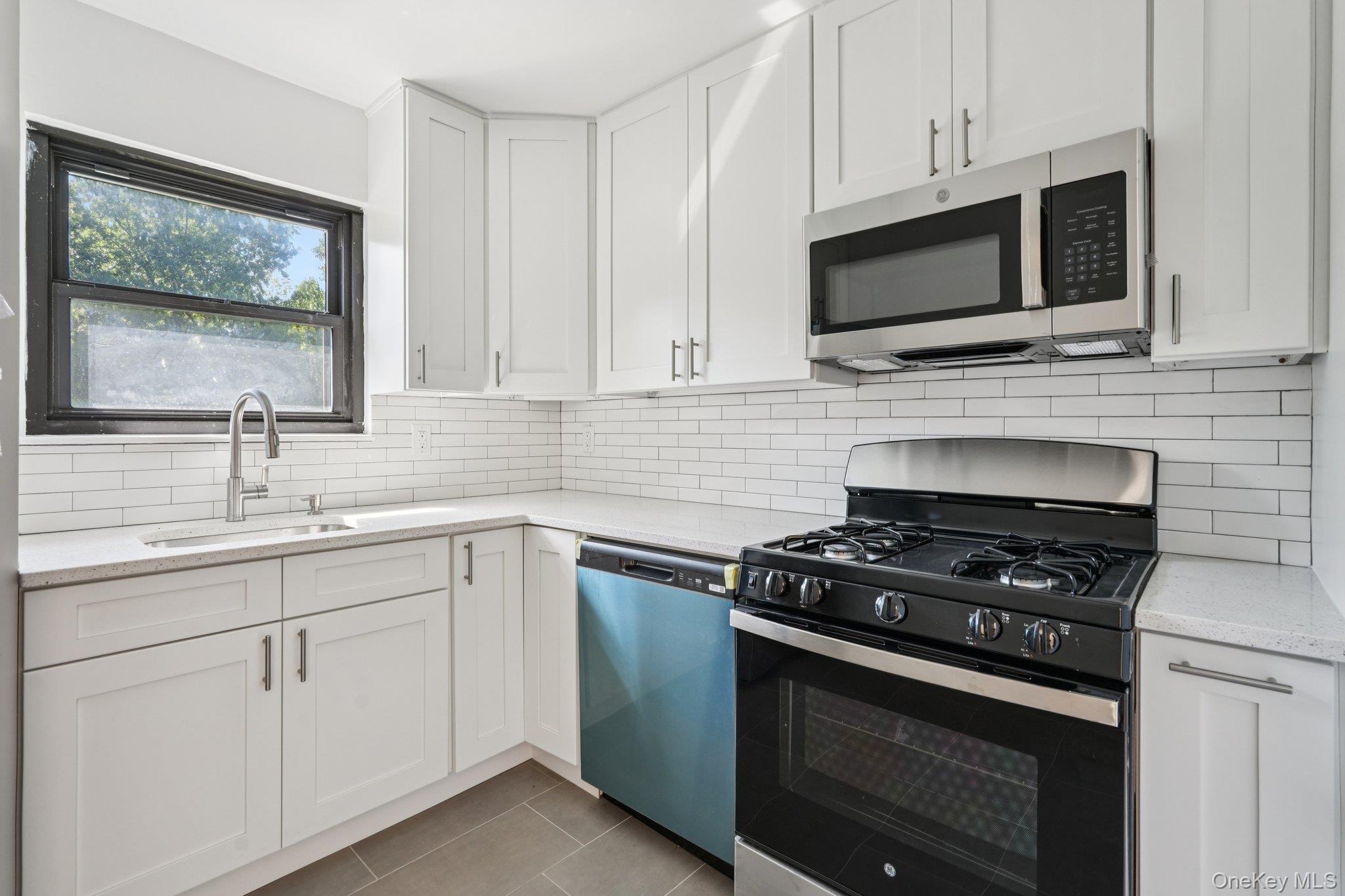 148 Sneden Place West, Unit 148 Spring Valley, NY 10977 - Photo 24 of 37 a kitchen with cabinets stainless steel appliances and a sink