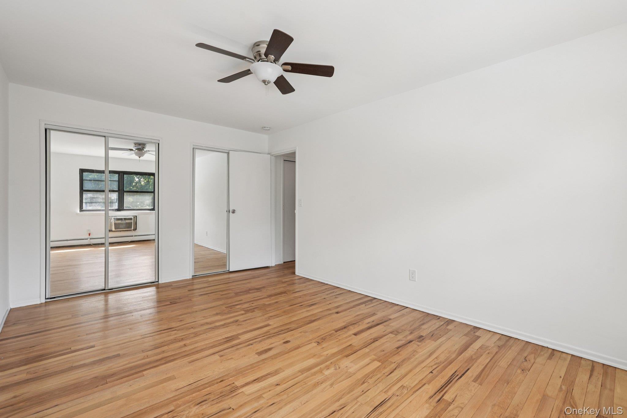 148 Sneden Place West, Unit 148 Spring Valley, NY 10977 - Photo 28 of 37 a view of empty room with wooden floor and window