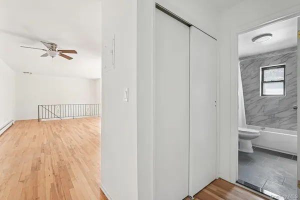 a bathroom with a granite countertop sink a toilet and shower