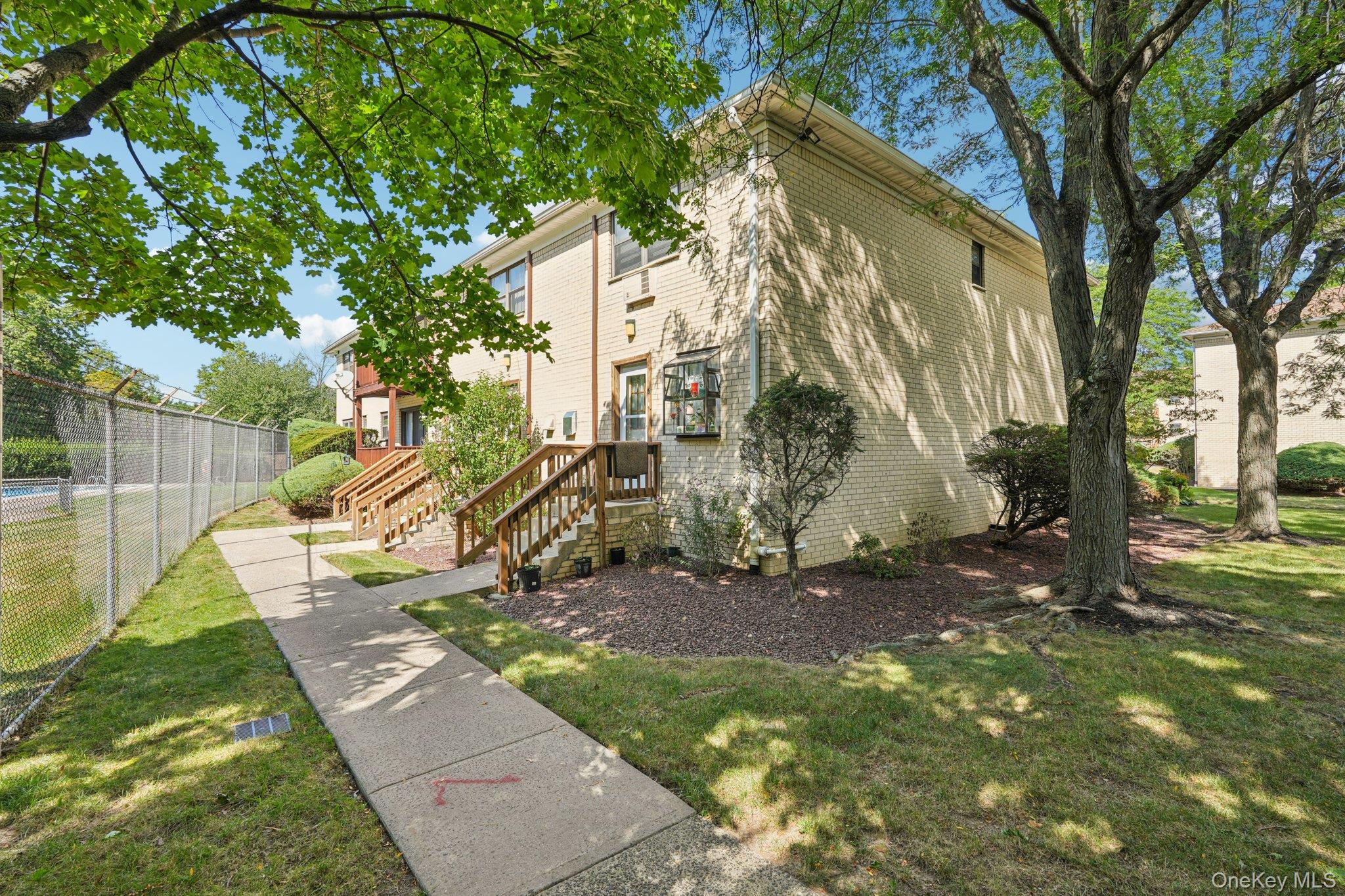148 Sneden Place West, Unit 148 Spring Valley, NY 10977 - Photo 3 of 37 a view of a yard with a tree