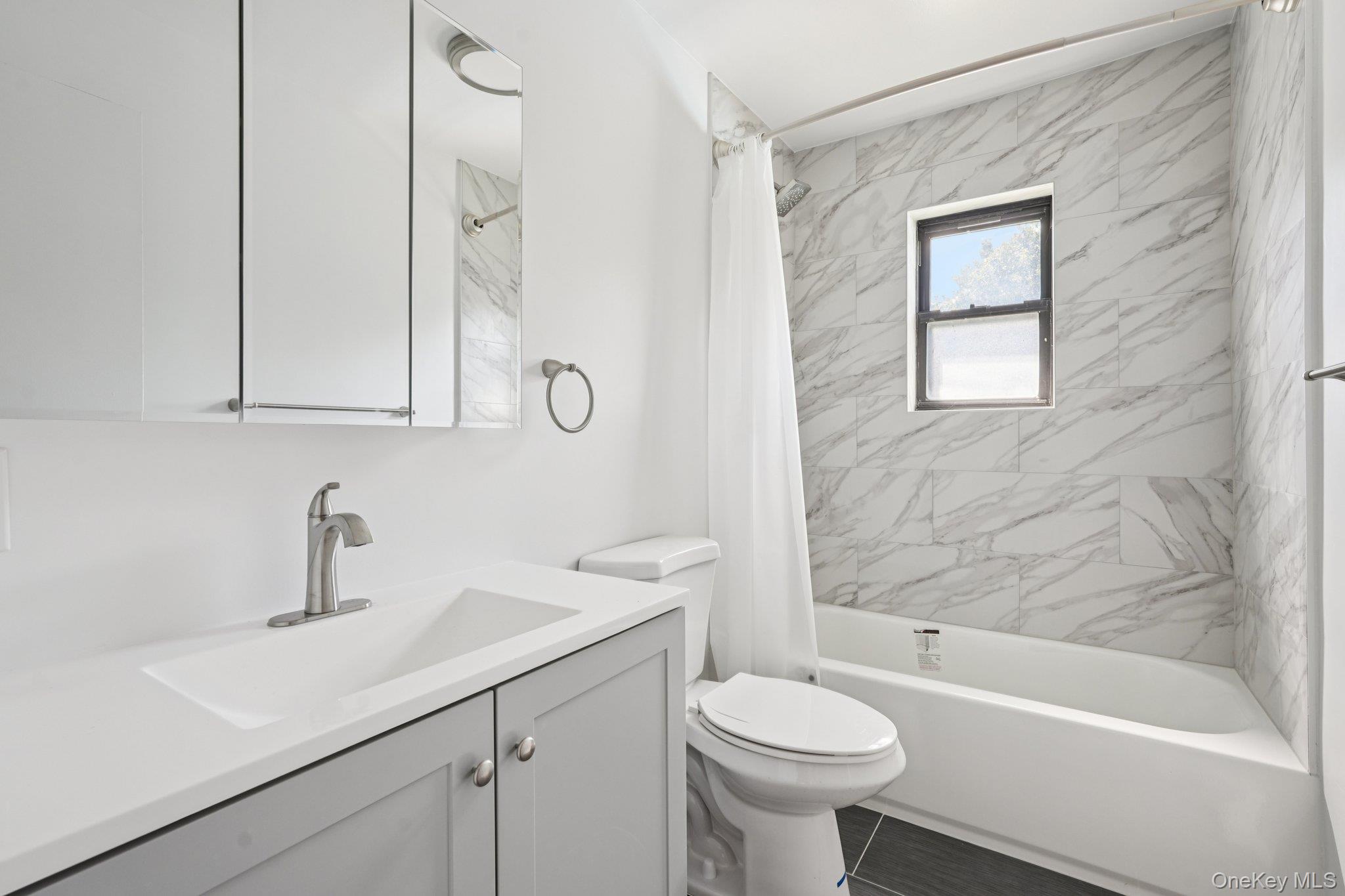 148 Sneden Place West, Unit 148 Spring Valley, NY 10977 - Photo 31 of 37 a bathroom with a sink a toilet and shower