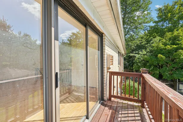 a view of a balcony with wooden floor