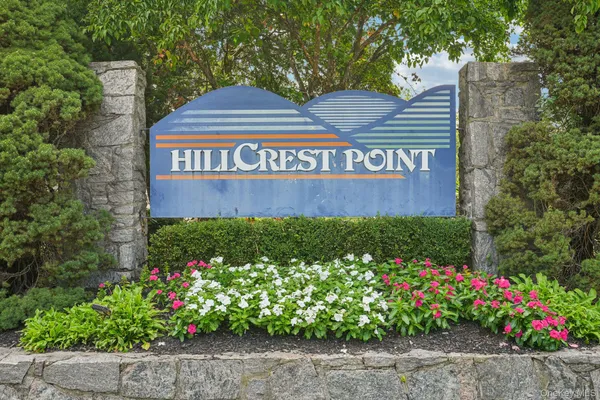 a view of sign board with flower around