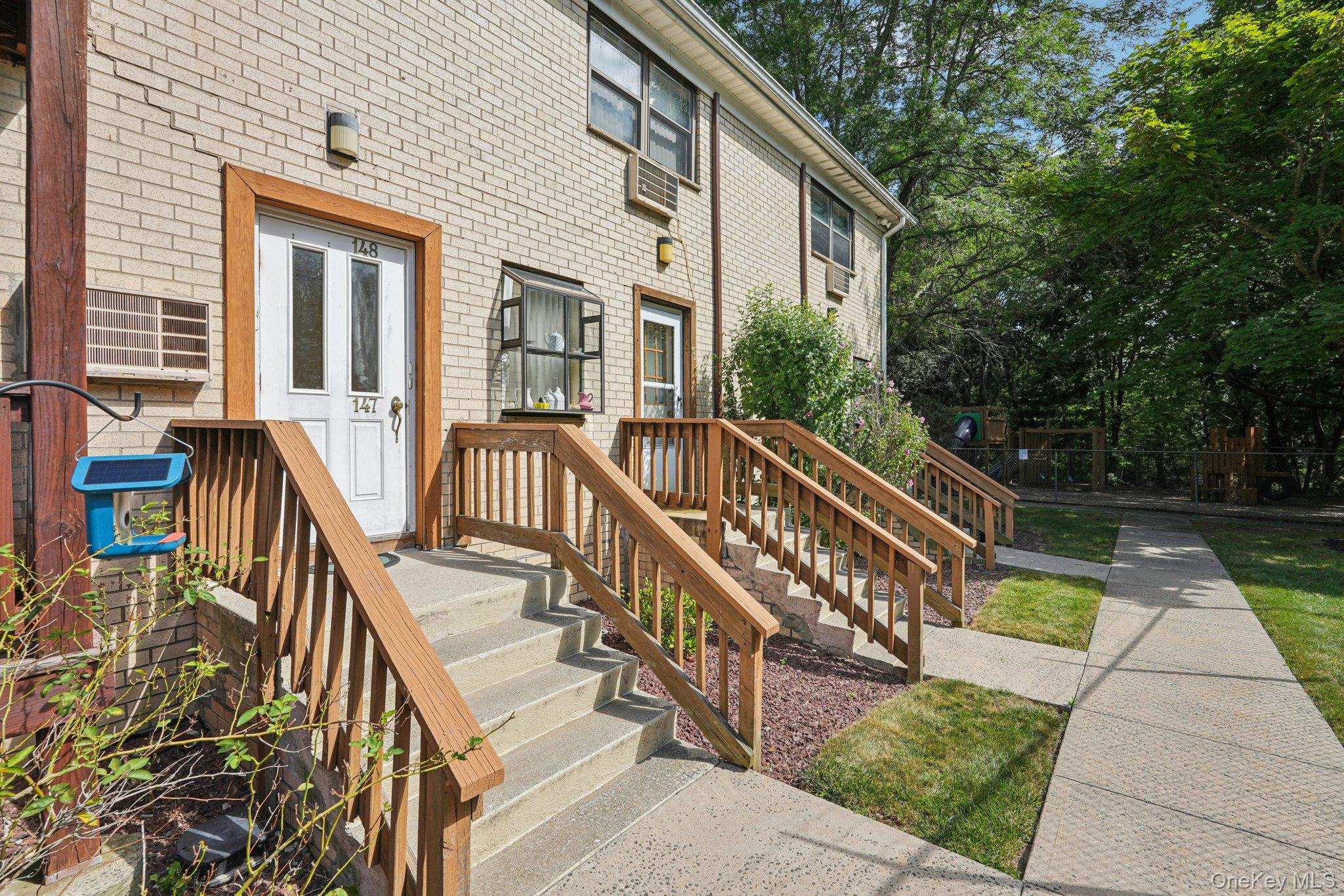 148 Sneden Place West, Unit 148 Spring Valley, NY 10977 - Photo 6 of 37 a view of a house with backyard and deck