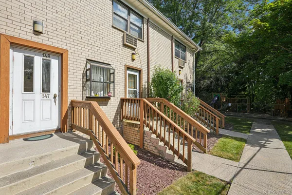 a view of a house with backyard and deck
