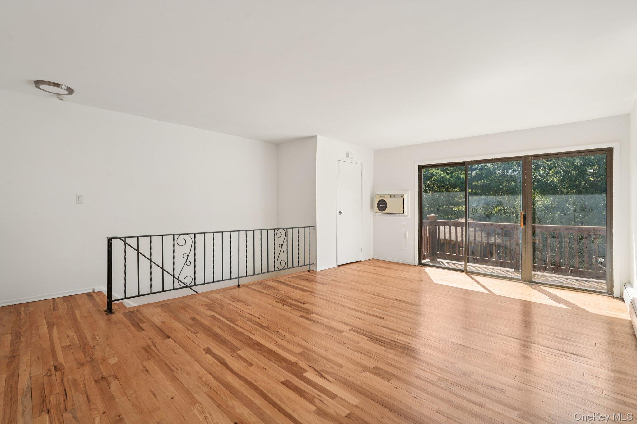 148 Sneden Place West, Unit 148 Spring Valley, NY 10977 - Photo 9 of 37 a view of an empty room with wooden floor and a window