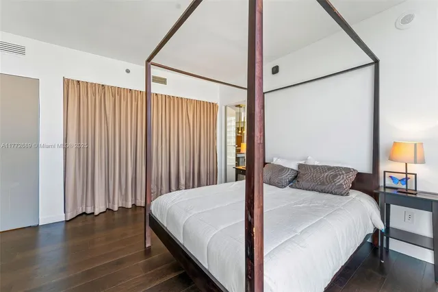 a bedroom with a bed and a night stand