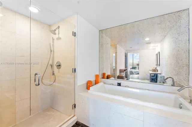 a bathroom with a double vanity sink mirror and shower