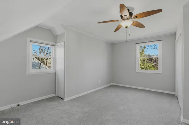 a view of empty room with ceiling fan