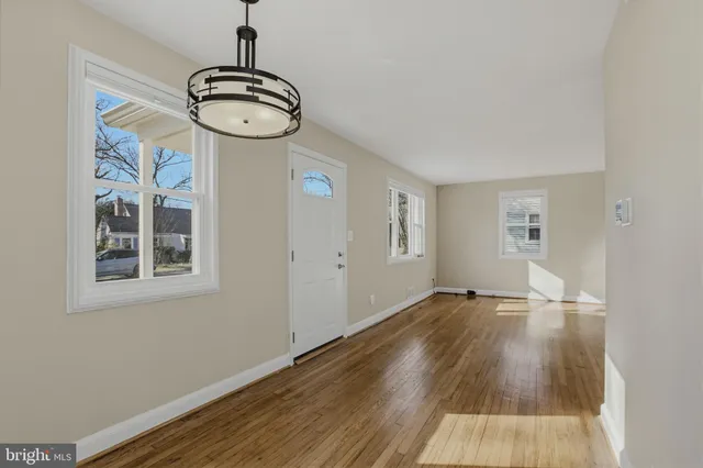 a view of a room with wooden floor and white walls