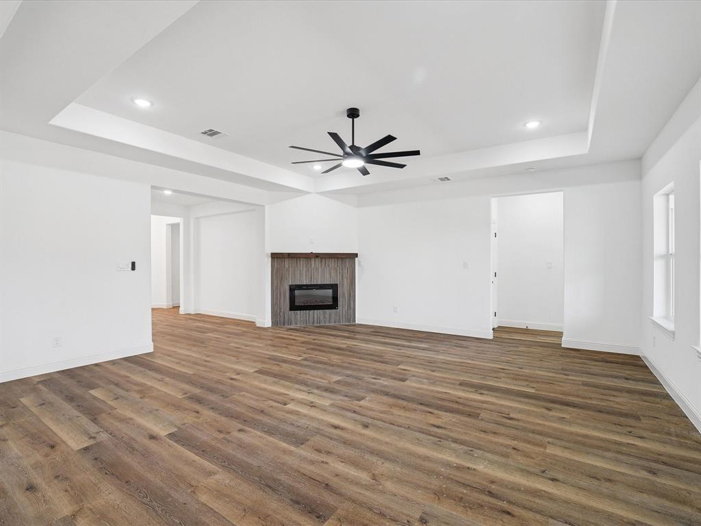 448 Rs County Road Alba, TX 75410 - Photo 16 of 34 a view of an empty room with chandelier fan and wooden floor