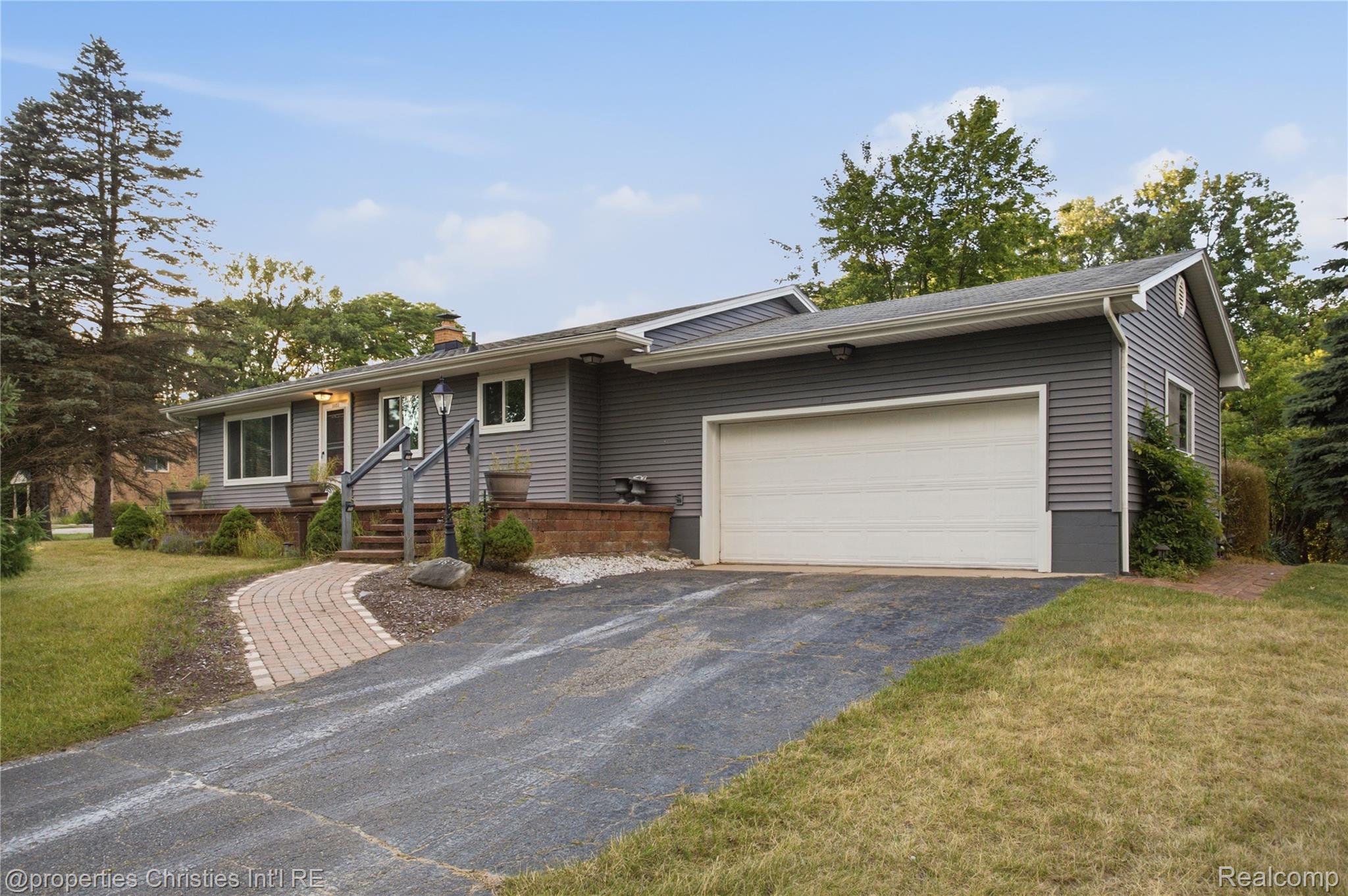 3851 Judd Road Milan, MI 48160 - Photo 2 of 41 Gray horizontal siding exterior with a white garage door