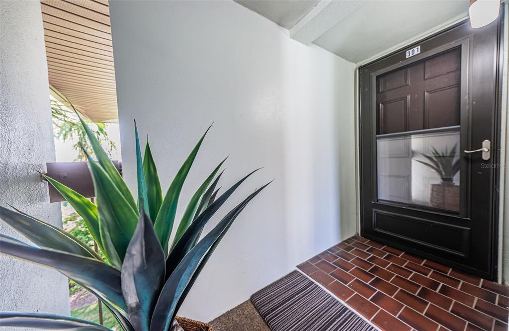 5157 Silent Loop, Unit 301 New Port Richey, FL 34652 - Photo 11 of 71 a view of a hallway with wooden floor and a potted plant